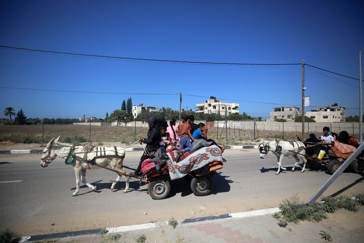 Palestinians with their belongings flee to safer areas in Gaza City after Israeli air strikes, on October 13, 2023. Israel has called for the immediate relocation of 1.1 million people in Gaza amid its massive bombardment in retaliation for Hamas's attacks, with the United Nations warning of ''devastating'' consequences. (Photo by Majdi Fathi/NurPhoto via Getty Images)