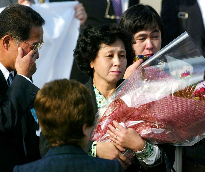 北朝鮮から24年ぶりに帰国し、再会を果たした拉致被害者の曽我ひとみさん（中央、43歳）と妹の金子富美子さん（右後方）＝2002年10月15日、東京・羽田空港