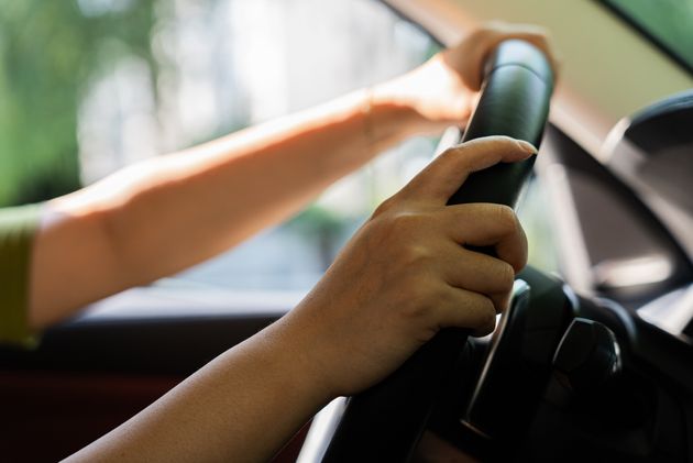 women hand driving car