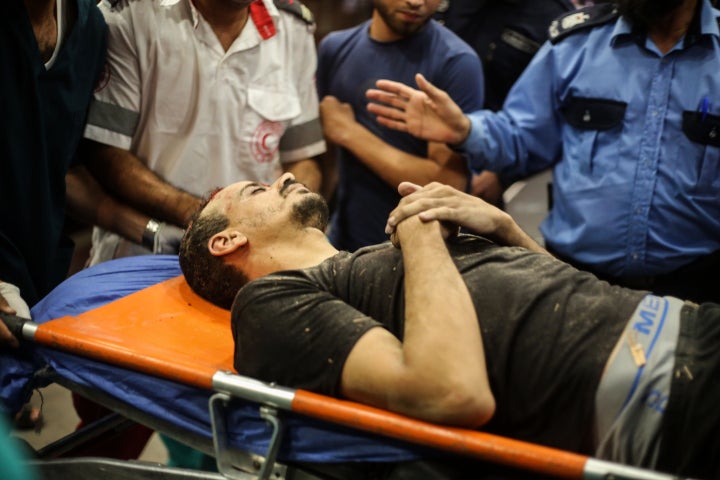 Palestinians injured during Israeli raids arrive at Nasser Hospital south of the Gaza Strip. (Photo by Ahmad Hasaballah/Getty Images)