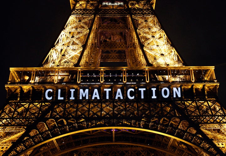 The slogan "Climataction" is projected on the Eiffel Tower as part of the World Climate Change Conference 2015 (COP21) on December 11, 2015