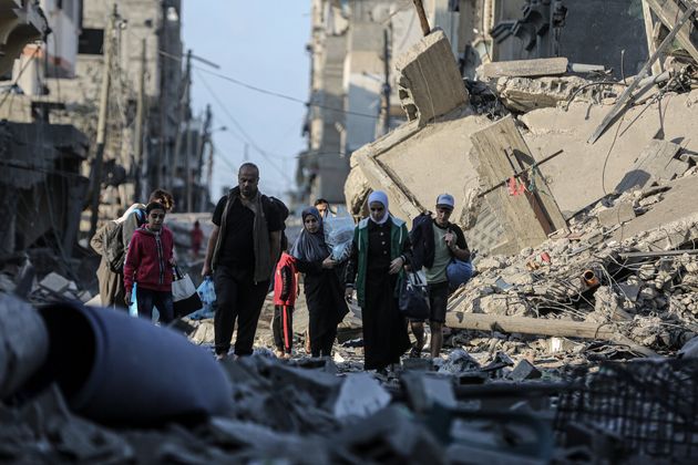 Palestinians carrying belongings flee to safer areas following Israeli bombardments on southern part of Gaza City, Tel al-Hawa neighborhood, Gaza on October 16, 2023.