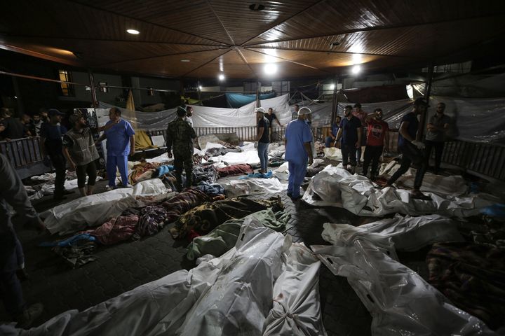 Bodies of Palestinians killed by an explosion at the Ahli Arab hospital are gathered in the front yard of the al-Shifa hospital, in Gaza City, central Gaza Strip, Tuesday, Oct. 17, 2023. The Hamas-run Health Ministry says an Israeli airstrike caused an explosion that killed hundreds at the Ahli Arab hospital, but the Israeli military says it was a misfired Palestinian rocket. (AP Photo/Abed Khaled)