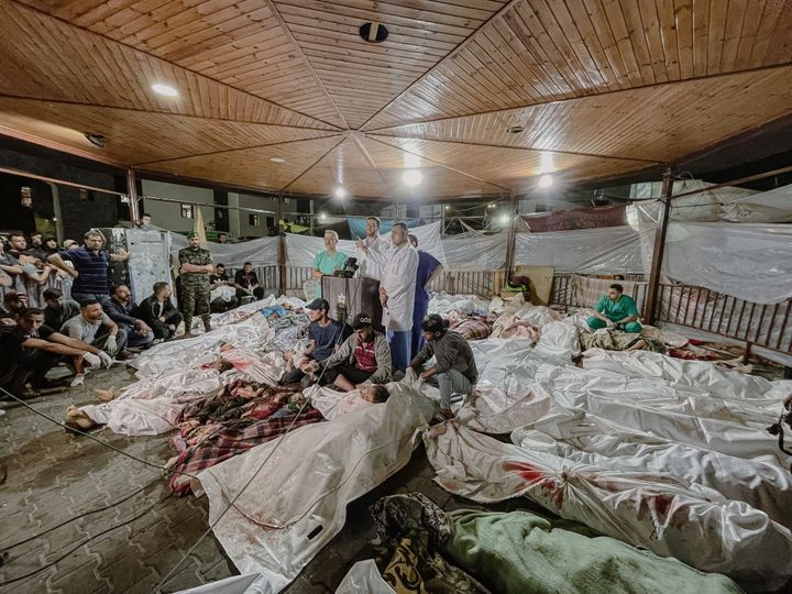 Amid the tragic aftermath of the bombing of Gaza's Al-Ahli Baptist Hospital on Tuesday, doctors at Al-Shifa Hospital gather to make a press statement, surrounded by lifeless Palestinian bodies.