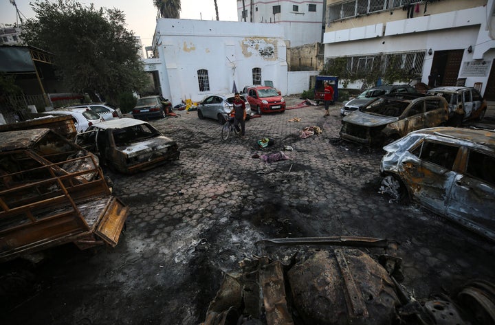 Palestinians check the place of the explosion at al-Ahli hospital, in Gaza City, Wednesday, Oct. 18, 2023.