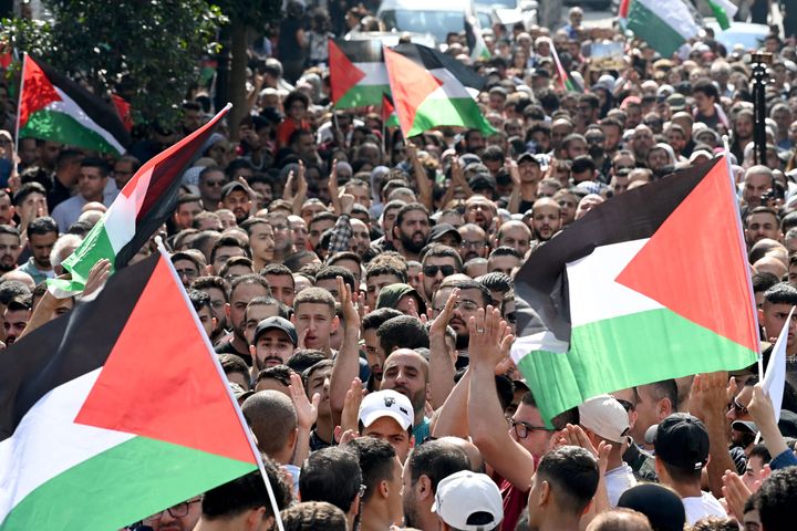 Palestinians wave the national flag during a demonstration in the city of Ramallah, in the occupied West Bank on October 18, 2023, protesting a strike on a Gaza hospital which killed hundreds a day earlier. Israel and Palestinians traded blame for the incident, which an "outraged and deeply saddened" US President Joe Biden denounced during a visit to the Middle East. Neither the Israeli nor the Palestinian accounts could be independently corroborated. (Photo by YURI CORTEZ / AFP) (Photo by YURI CORTEZ/AFP via Getty Images)