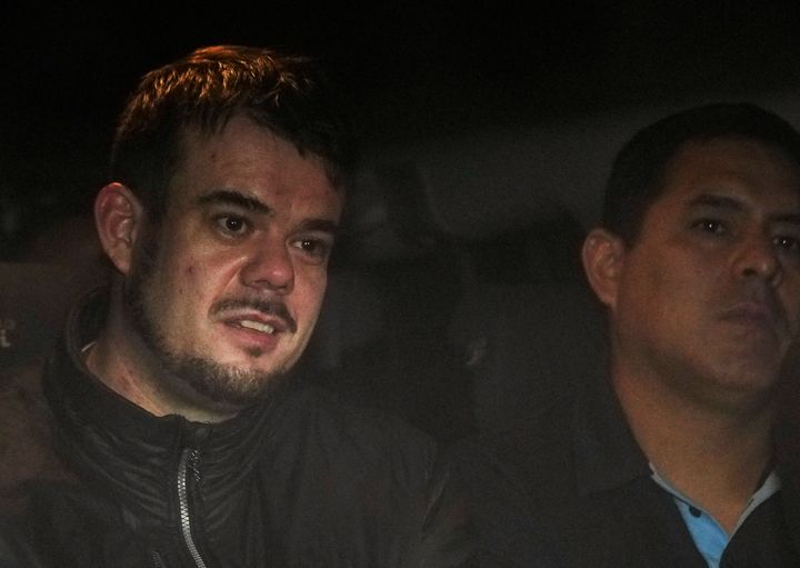 Dutch citizen Joran van der Sloot, left, is driven in a police vehicle from a maximum-security prison to an airport to be extradited to the U.S., on the outskirts of Lima, Peru, Thursday, June 8, 2023. 