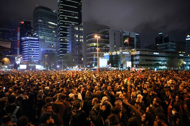 People gather outside the Israeli consulate during a protest to show solidarity with Palestinians, in Istanbul, Turkey, Tuesday, Oct. 17, 2023. A massive blast rocked a Gaza City hospital packed with wounded and other Palestinians seeking shelter Tuesday, killing hundreds of people, the Hamas-run Health Ministry said. Hamas blamed an Israeli airstrike, while the Israeli military said the hospital was hit by a rocket misfired by Palestinian militants.