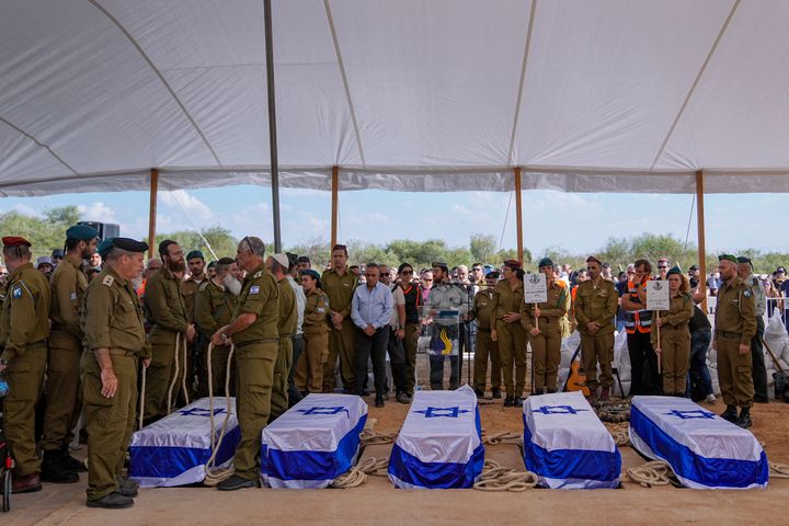 Mourners gather around the five coffins of the Kotz family during their funeral in Gan Yavne, Israel, Tuesday, Oct. 17, 2023. The family was killed by Hamas militants on Oct. 7 at their house in Kibbutz Kfar Azza near the border with the Gaza Strip, More than 1,400 people were killed and some 200 captured in an unprecedented, multi-front attack by the militant group that rules Gaza. (AP Photo/Ohad Zwigenberg)