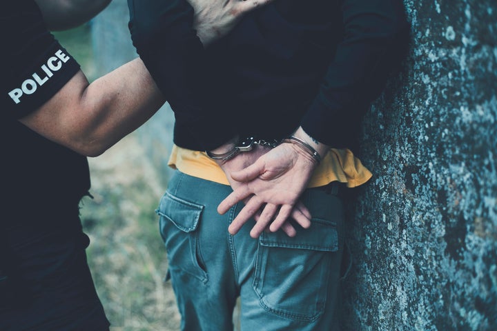 Police putting handcuffs on a man