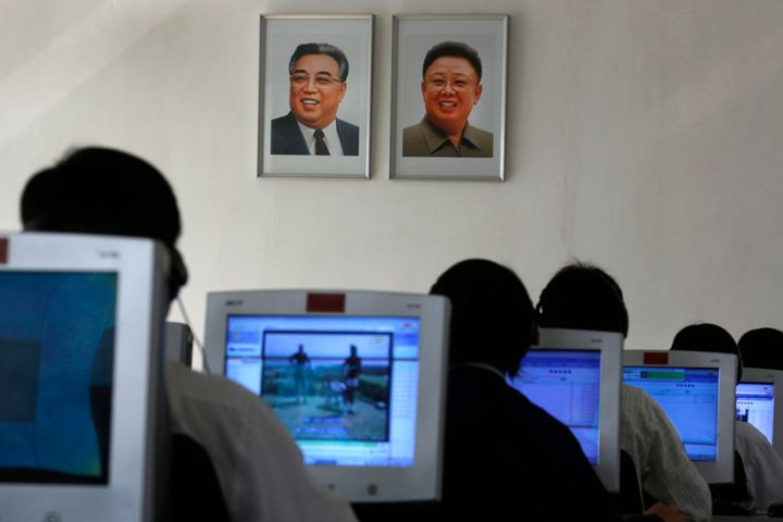 North Korean students use computers near portraits of the country's later leaders Kim Il Sung, left, and his son Kim Jong Il in Pyongyang, North Korea, Thursday, Sept. 20, 2012. (AP Photo/Vincent Yu)