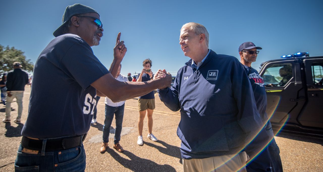 Chester Watts (left) of Jackson, Mississippi, speaks with Presley while tailgating at the Jackson State University homecoming football game on Oct. 14