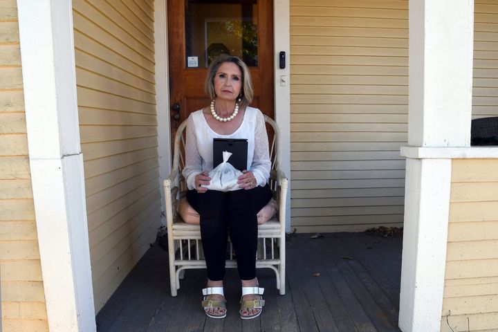 Abby Swoveland sits with what the Return to Nature Funeral Home said were her mother's ashes in Colorado Springs, Colo., on Thursday, Oct. 19, 2023. (AP Photo/Thomas Peipert)