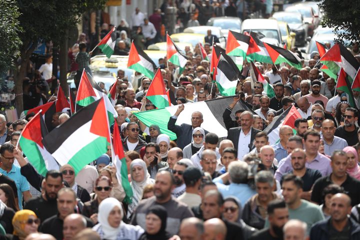 People holding Palestinian flags, gather to attend a pro-Palestinian demonstration in Ramallah, West Bank on October 19, 2023.