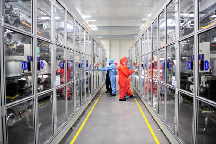 Employees work on the production line of lithium batteries at the workshop of a new energy lithium battery industrial park on Aug. 28 in Yichang, Hubei Province of China.