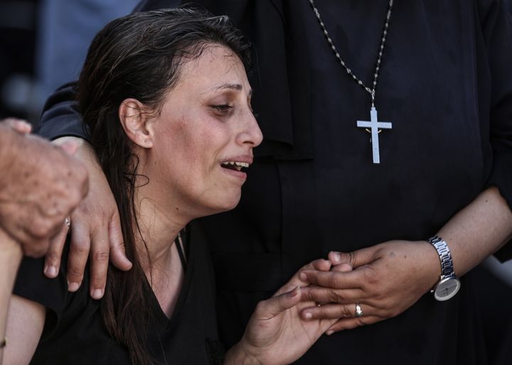 GAZA CITY, GAZA - OCTOBER 20: Relatives mourn during the funeral ceremony for Palestinians who lost their lives in Israeli attack on Church of Saint Porphyrius in Gaza City, Gaza on October 20, 2023. (Photo by Ali Jadallah/Anadolu via Getty Images)