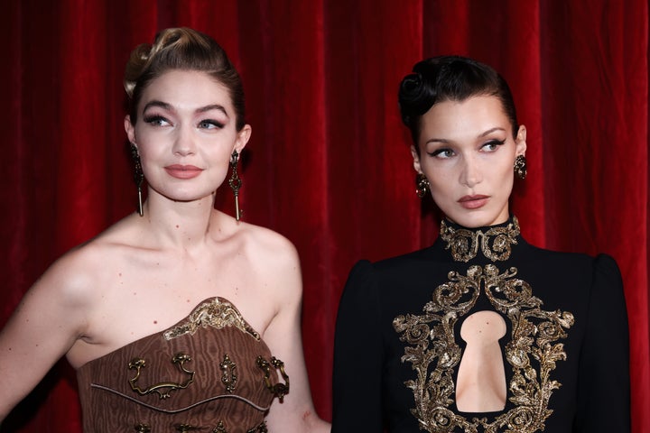 Gigi Hadid and Bella Hadid pose backstage of the Moschino fashion show during the Milan Fashion Week Fall/Winter 2022/2023.