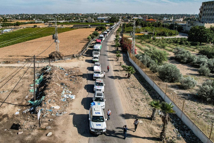 TOPSHOT - This aerial view shows humanitarian aid trucks arriving from Egypt after having crossed through the Rafah border crossing arriving at a storage facility in Khan Yunis in the southern Gaza Strip on October 21, 2023. The first aid trucks arrived in war-torn Gaza from Egypt on October 21, bringing urgent humanitarian relief to the Hamas-controlled Palestinian enclave suffering what the UN chief labelled a "godawful nightmare". Israel has vowed to destroy Hamas after the Islamist militant group carried out the deadliest attack in the country's history on October 7. (Photo by Belal Al SABBAGH / AFP) (Photo by BELAL AL SABBAGH/AFP via Getty Images)