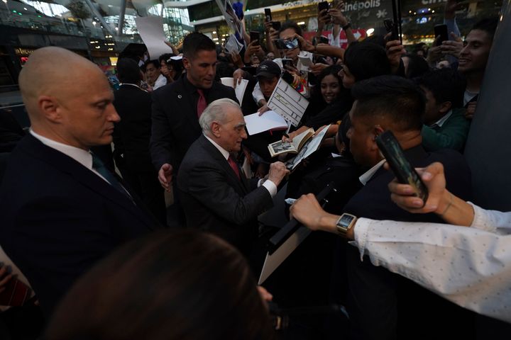 Director-producer Martin Scorsese, center, signs autographs upon arrival for the premiere of the film Killers of the Flower Moon, in Mexico City, Wednesday, Oct. 11, 2023. (AP Photo/Marco Ugarte)