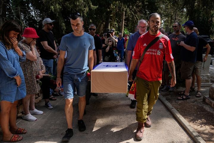 Mourners carry the coffin of Roee Munder during his funeral in Kibbutz Metzer, Israel, Sunday, Oct. 22, 2023. Munder was killed by Hamas militants at his house in Kibbutz Nir Oz near the border with the Gaza Strip. On Oct. 7, more than 1,400 people were killed and more than 200 captured in an unprecedented, multi-front attack on Israel by the militant group that rules Gaza. (AP Photo/Ohad Zwigenberg)