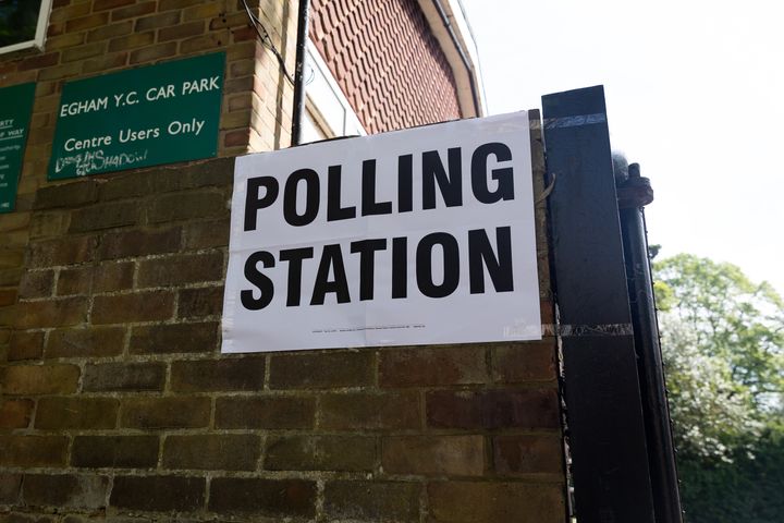 General view of a polling station in Egham, as members of the public go to cast their votes. 