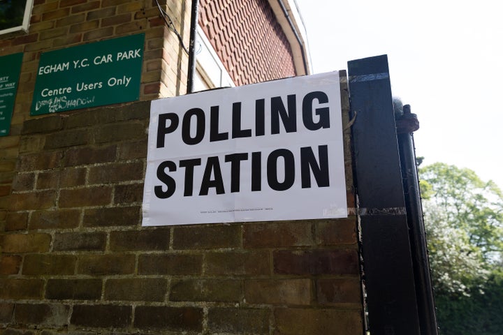 General view of a polling station in Egham, as members of the public go to cast their votes.