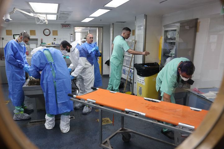 Forensic scientists at Israel's National Center for Forensic Medicine in Tel Aviv work to identify bodies of those killed in attacks by Hamas.
