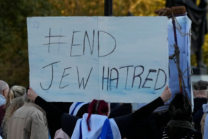 An Israeli supporter holds up a placard saying 'End Jew Hatred' as she takes part in a protest where placards with the faces and names of people believed taken hostage 