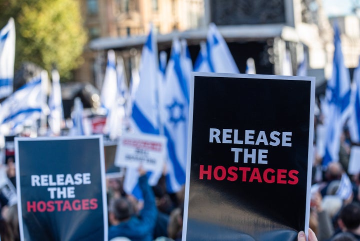 Protesters wave flags and hold placards expressing their opinion during the demonstration in Trafalgar Square in London.