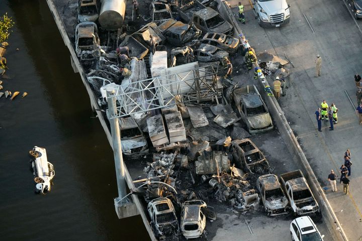In this aerial photo, responders are seen near wreckage in the aftermath of a multi-vehicle pileup on I-55 in Manchac, La., Monday, Oct. 23, 2023. A “superfog” of smoke from south Louisiana marsh fires and dense morning fog caused multiple traffic crashes involving scores of cars. (AP Photo/Gerald Herbert)