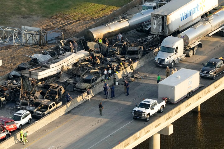 In this aerial photo, responders are seen near wreckage in the aftermath of a multi-vehicle pileup on I-55 in Manchac, La., Monday, Oct. 23, 2023. A “superfog” of smoke from south Louisiana marsh fires and dense morning fog caused multiple traffic crashes involving scores of cars. (AP Photo/Gerald Herbert)