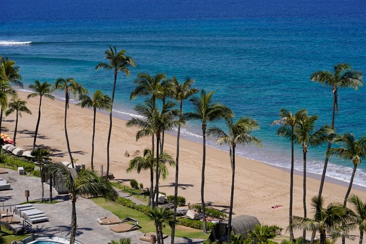 An empty Kaanapali Beach is shown, Sunday, Aug. 13, 2023, in Kaanapali, near Lahaina, Hawaii, following wildfires that caused heavy damage in the area.