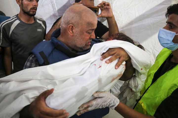 Al Jazeera correspondent Wael Dahdouh mourns Wednesday over the body of his daughter, who was killed along with his wife in an Israeli strike in the Nuseirat camp, at Al-Aqsa hospital in Deir Al-Balah in southern Gaza. 