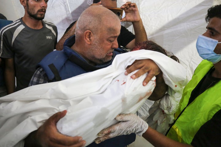 Al Jazeera correspondent Wael Dahdouh mourns Wednesday over the body of his daughter, who was killed along with his wife in an Israeli strike in the Nuseirat camp, at Al-Aqsa hospital in Deir Al-Balah in southern Gaza. 