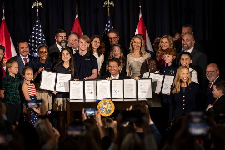 Florida Gov. Ron DeSantis poses for a photo after signing a host of new laws targeting transgender children and drag shows on May 17.