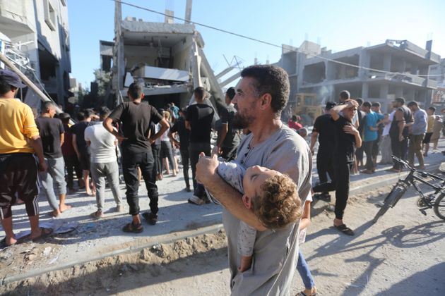 Palestinians look for survivors after an Israeli airstrike in Rafah in the Gaza Strip on Oct. 26.