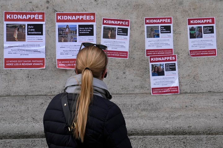 A woman looks at posters pasted by the UEJF (Union of Jewish French Students) on Oct. 16 in Paris.