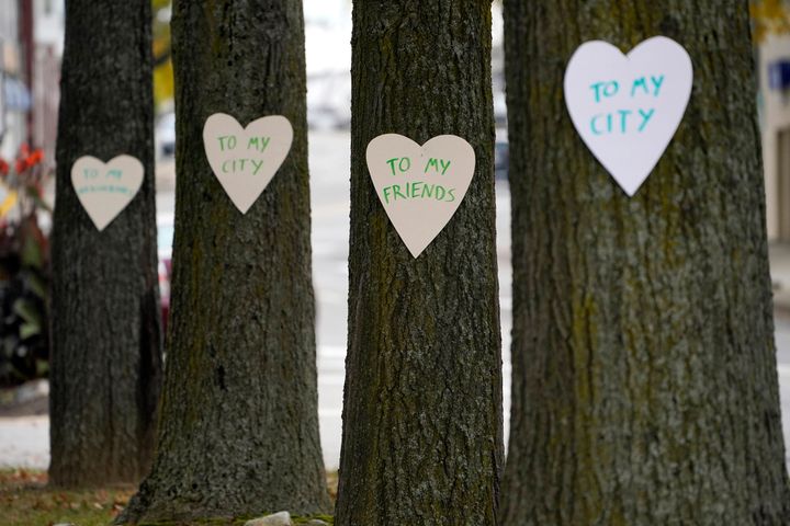 Heart-shaped cut-outs with messages of positivity adorn trees in downtown Lewiston, Maine, on Thursday.
