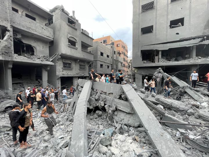 Palestinians look for survivors after an Israeli airstrike on buildings at Shati refugee camp, Gaza Strip, Friday, Oct. 27, 2023. (AP Photo/Mohammed Al Masri)