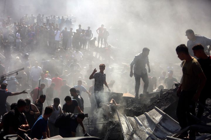 Palestinians inspect the rubble of destroyed buildings following Israeli airstrikes on the town of Khan Younis, southern Gaza.