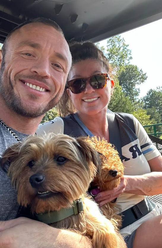 The author and Cam pose with their dogs, Dax and Daisy.