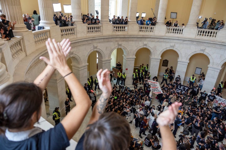 Demonstrators, calling for a ceasefire in the ongoing war between Israel and Hamas, chant and cheer during a protest inside the Cannon House Office Building at the Capitol in Washington on Wednesday, Oct. 18, 2023. (AP Photo/Amanda Andrade-Rhoades)