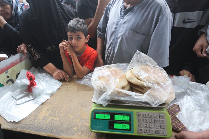 Palestinians wait to buy bread during the ongoing bombardment of the Gaza Strip in Rafah on Sunday, Oct. 29, 2023. (AP Photo/Hatem Ali)