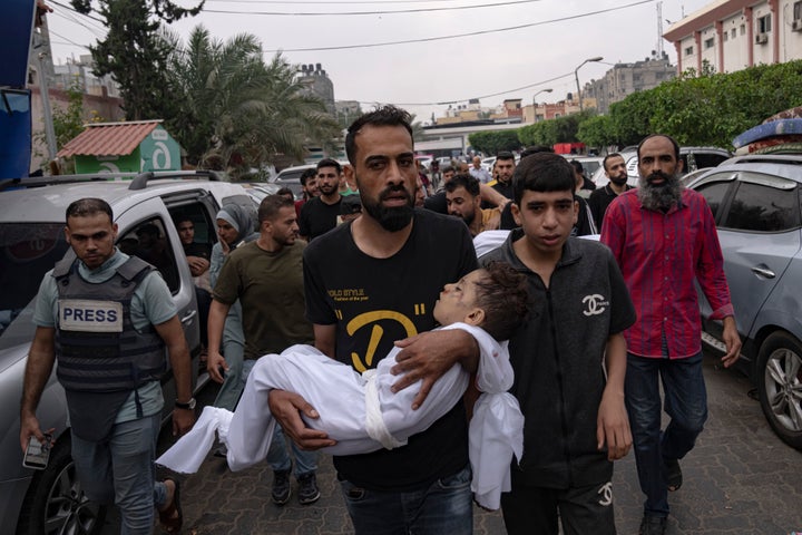 Palestinian mourners carry the body of their relatives killed in the Israeli bombardment of the Gaza Strip, in Khan Younis, Sunday, Oct. 29, 2023. (AP Photo/Fatima Shbair)