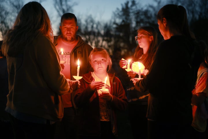 (L-R) Adam Jones, Sadie Huntley, and Skylar Meserve during a candlelight vigil to honor the victims of the Lewiston shootings on October 28, 2023 in Lisbon, Maine. Card allegedly killed 18 people in a mass shooting at a bowling alley and a restaurant in Lewiston and was found dead in Lisbon.