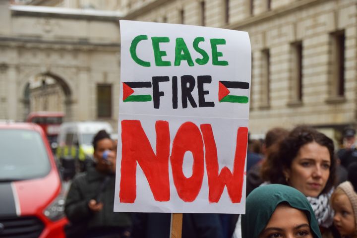 A protester holds a 'Ceasefire now' placard during the demonstration in London.