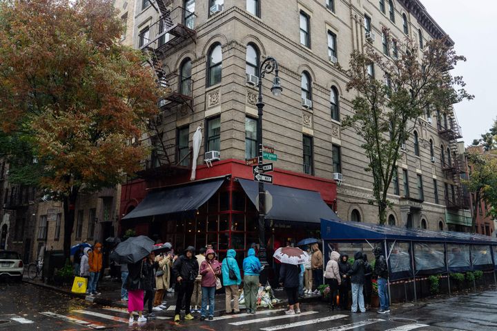 People stand in line to pay tribute to actor Matthew Perry outside the apartment building which was used in exterior shots in Friends