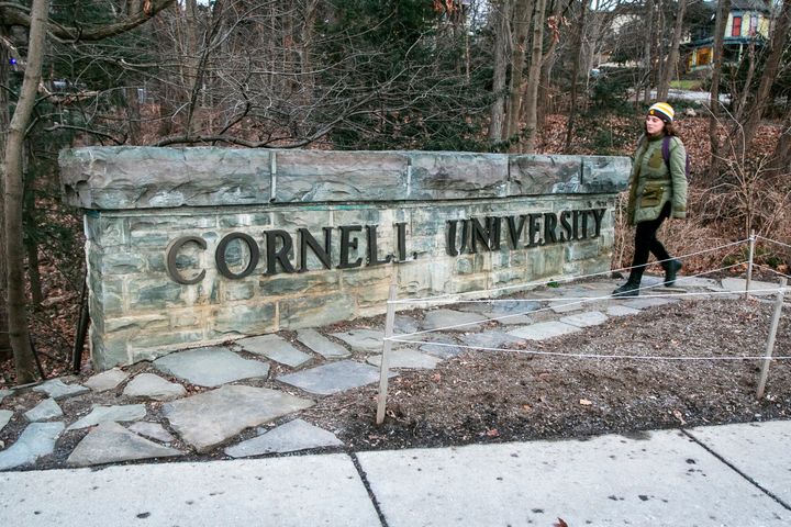 A woman walks by a Cornell University sign on the Ivy League school's campus in Ithaca, New York. Cornell University administrators dispatched campus police to a Jewish center after threatening statements appeared on a discussion board Sunday.