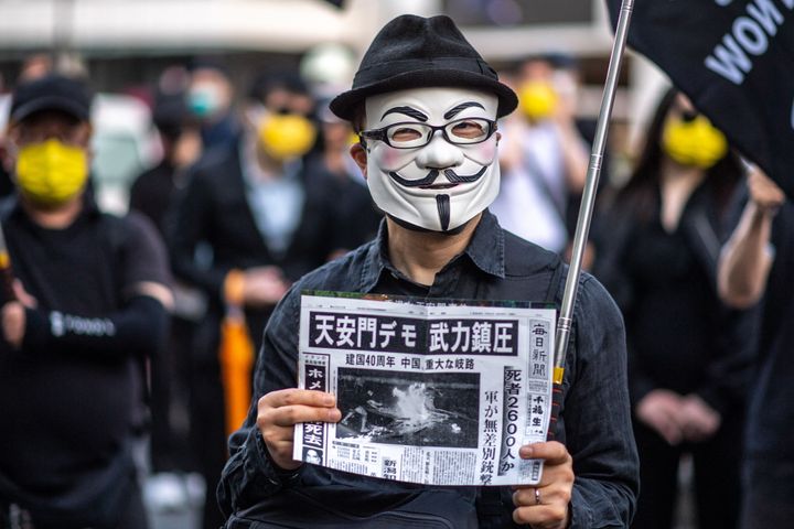 Fawkes' influence now stretches around the world – here's a pro-democracy activist wearing a Guy Fawkes mask while attending a vigil outside a train station in Shinjuku district of Tokyo on June 4, 2022.