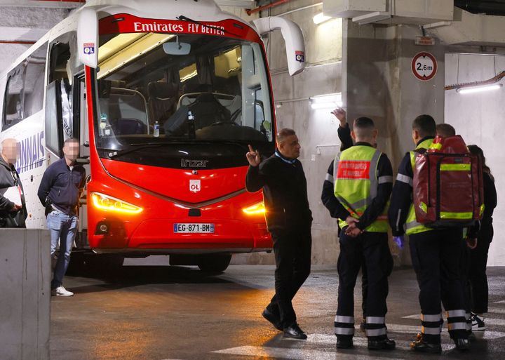 Firefighters stand next to Lyon's team bus, showing one window completely broken and another damaged, after the bus was stoned as it entered the Stade Velodrome ahead of the French L1 football match between Olympique Marseille (OM) and Olympique Lyonnais (OL) at Stade Velodrome in Marseille. 